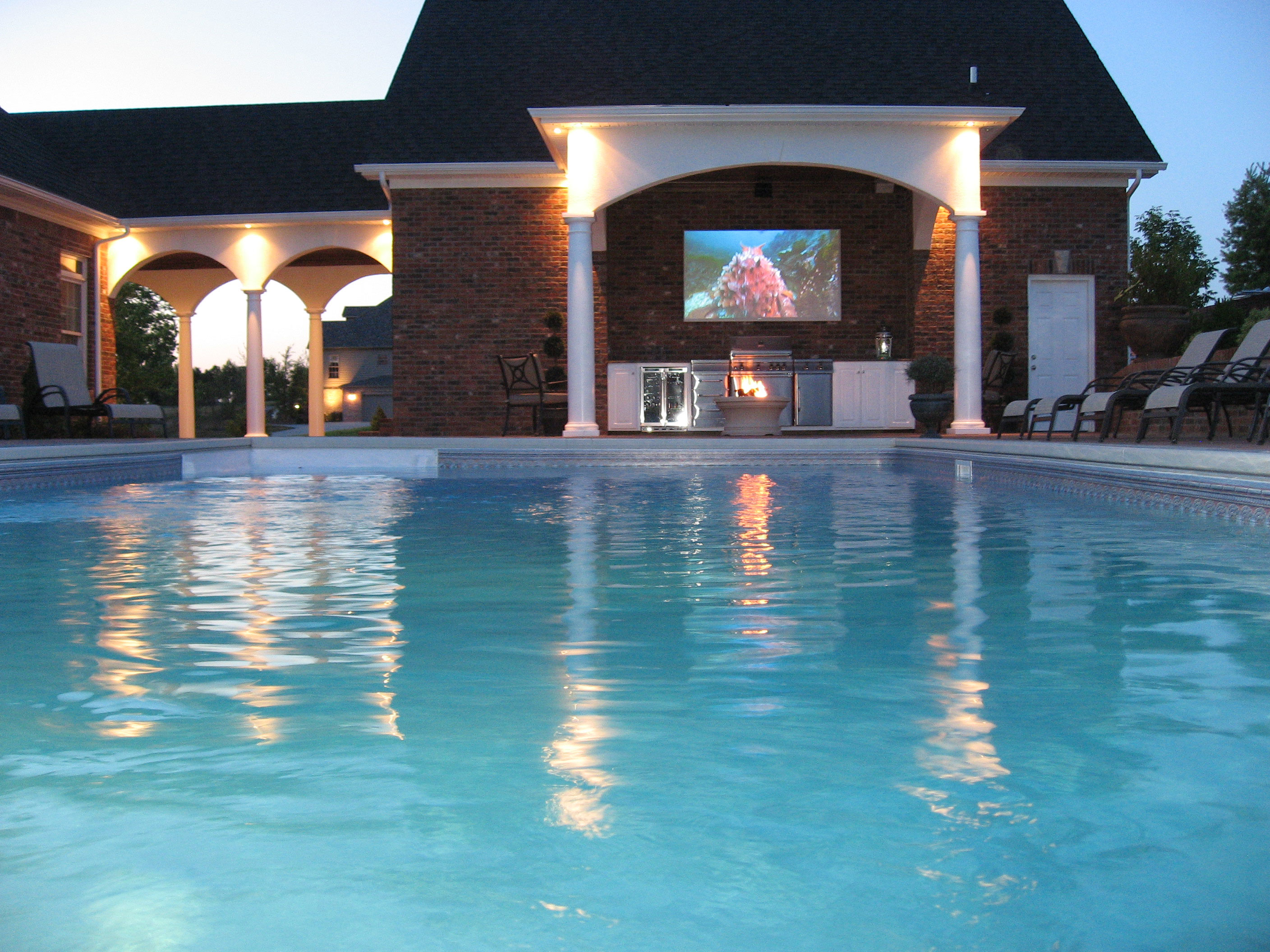 Outdoor pool with TV overlook.